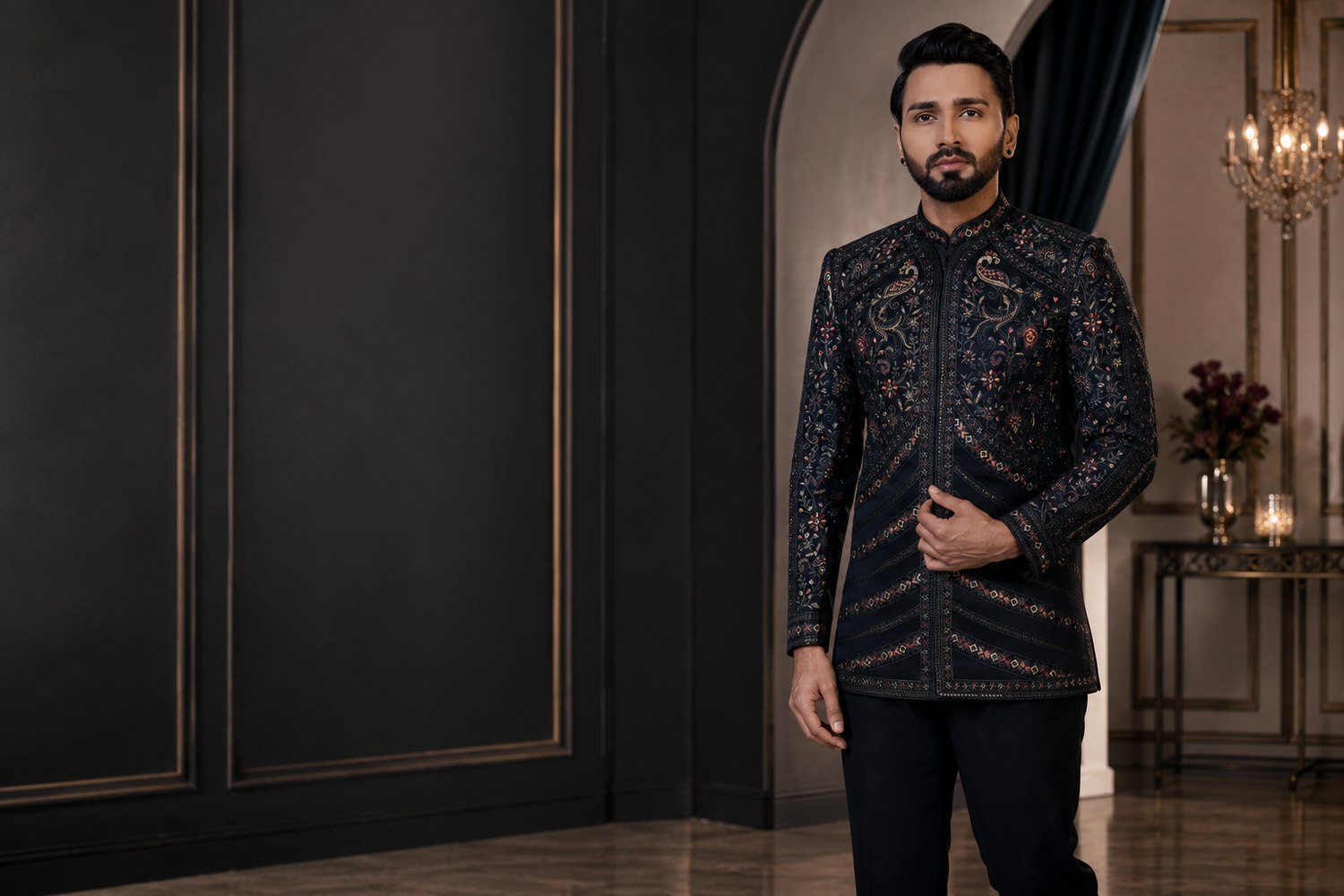 Luxury black embroidered Indo-Western sherwani for men with intricate floral detailing, styled in a dark premium reception-inspired interior with elegant lighting and modern royal aesthetics.